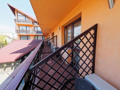 a balcony of a building with a stair railing at Hotel Oasis in Braşov