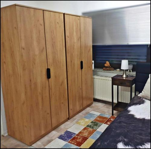 a large wooden cabinet in a bedroom with a bed at Hannis Appartement in Erkelenz