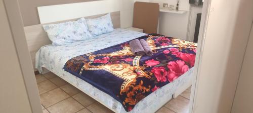 a bedroom with a bed with a colorful quilt at Bernina Station Center Appartment - Tirano in Tirano