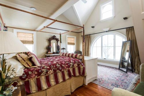 a bedroom with a bed and a large window at Magnificent Hudson River Estate in Coxsackie