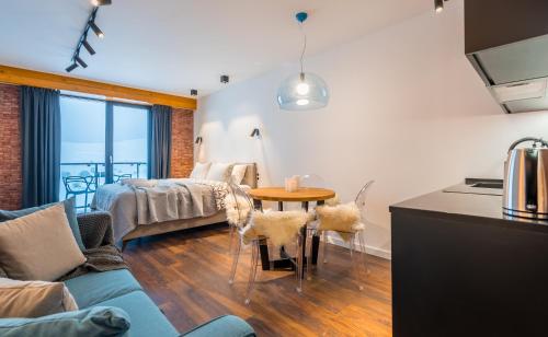 a kitchen and living room with a table and a couch at Gudauri Mountain Views in Gudauri