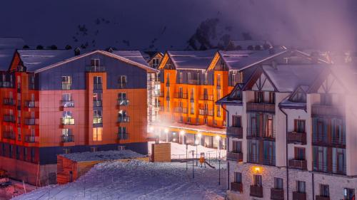 a group of buildings in the snow at night at Gudauri Mountain Views in Gudauri