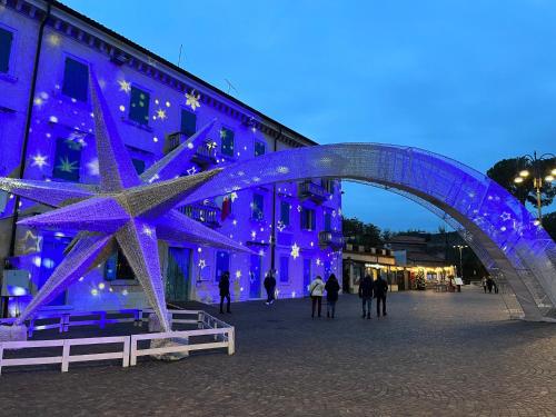 a blue building with a star under a bridge at Garda Art&Lake in Peschiera del Garda