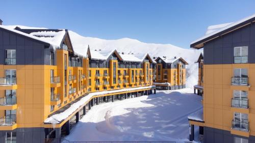a row of apartment buildings in the snow at Gudauri Mountain Views in Gudauri