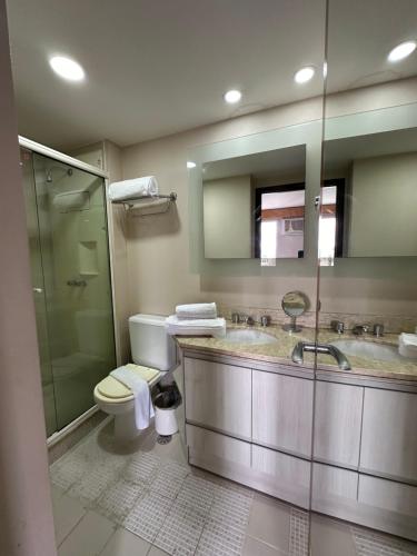 a bathroom with a toilet and a sink and a shower at Mercure São Paulo vila Olimpia premium in Sao Paulo