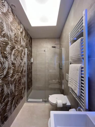 a bathroom with a shower and a toilet and a sink at MiAp ORTI 31 in Milan