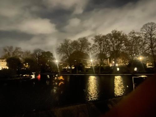 a view of a pond at night with lights at Sleepy Dragon in London