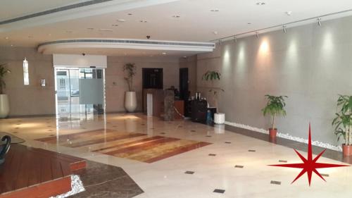 a large room with a star on the floor of a building at Amazing Rooms for Men Guests for rent in Dubai Marina in Dubai