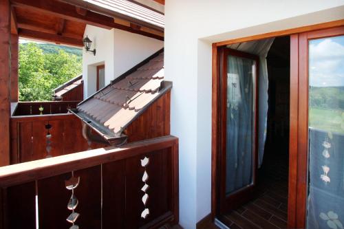 an open balcony with a glass door and a window at Gesztenyés Vendégház in Garáb