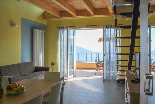 a living room with a staircase leading to a balcony at Residence Usignolo in Trarego