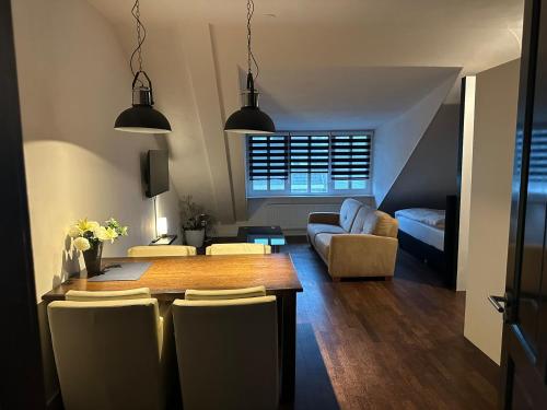 uma sala de estar com uma mesa e um sofá em B&B Santorini em Maasbree