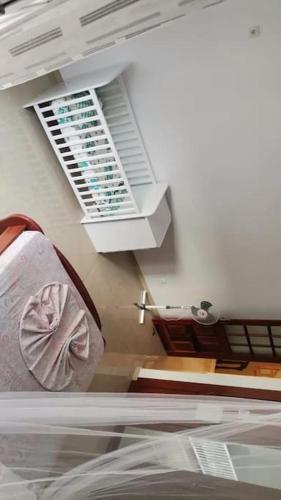 a view of a room with a bed and a window at Maison familiale à Tarrafal. in Tarrafal