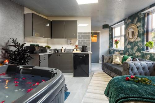 a kitchen and a living room with a hot tub at Riverside studio with Jacuzzi! in Sheffield