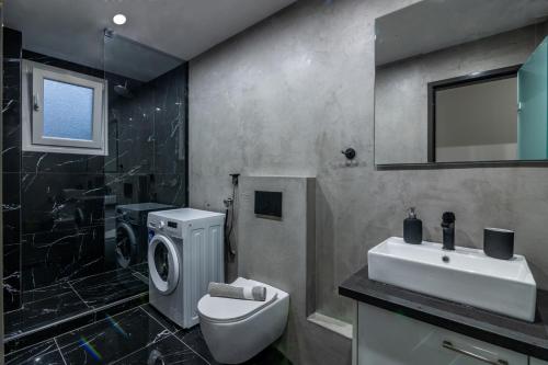 a bathroom with a toilet and a sink and a shower at Luxury Downtown Apartment Α3 in Thessaloniki