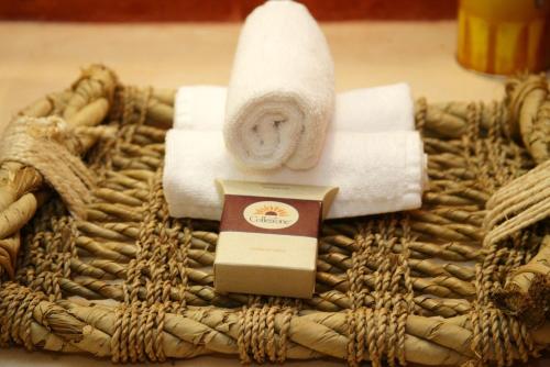 a towel with a roll of toilet paper and towels at Hacienda Santa Cruz Merida in Mérida