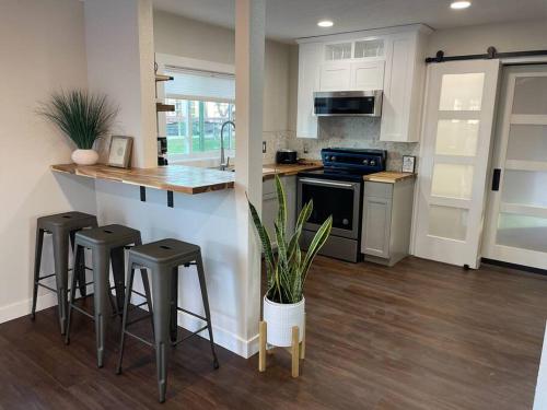 a kitchen with a counter and stools in it at Shares Courtyard Luxury Apt - NEW! in Rockledge