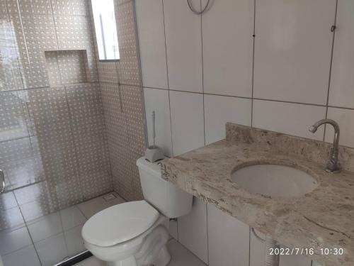 a bathroom with a toilet and a sink and a shower at RESIDENCIAL SOPHIA in Eunápolis