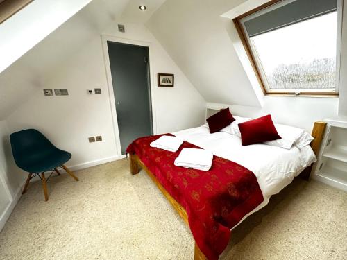 um quarto com uma cama, uma janela e uma cadeira em Dove House Cottages - No 2 em Witney