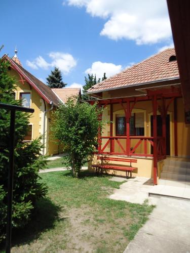 a house with a red bench in front of it at Prenoćište Vila Stara Breza in Palić