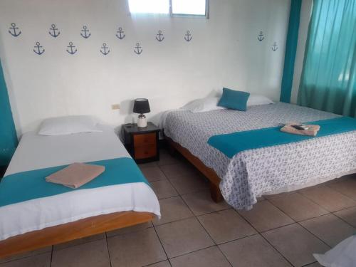 two beds sitting next to each other in a room at Descanso del Petrel in Puerto Ayora