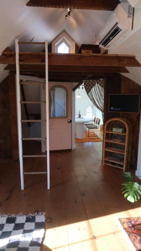 a room with a bunk bed and a living room at Creative Private Attic 1br Suite in Honey Brook