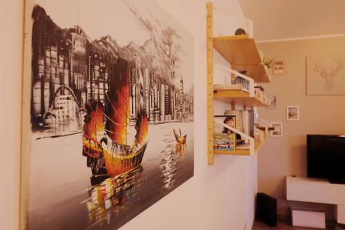 a painting hanging on a wall in a room at Orea Spiti - Modern Oasis Near Milan in Assago