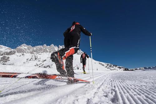 a man is skiing down a snow covered mountain at Central Hideaway in Maria Alm am Steinernen Meer