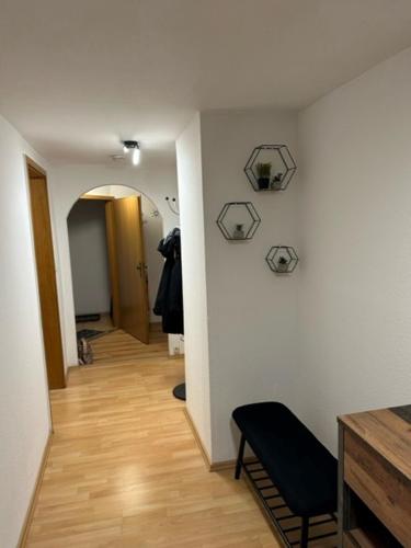 a room with a hallway with a chair and a wall at Ferienwohnung am Westerntor Jule inkl Parkplatz in Wernigerode
