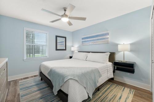 a bedroom with a bed and a ceiling fan at Red Neptune by Nautical Properties in Panama City Beach