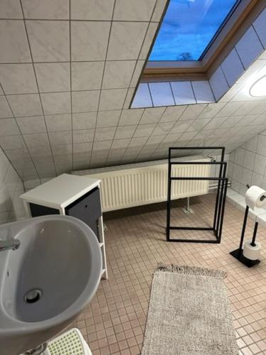 a bathroom with a large sink and a window at Ferienwohnung Jule in Wernigerode