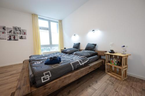 a bedroom with a large wooden bed with blue pillows at Suite mit Moselblick in Traben-Trarbach