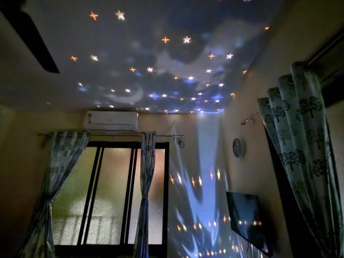 a room with a bunch of lights on the ceiling at Bhumi Holiday Home in Alibaug