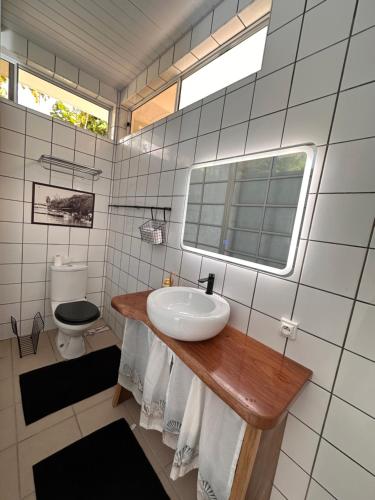 a bathroom with a sink and a toilet at Meri Lodge Huahine XXThe Bee HouseXX in Fare