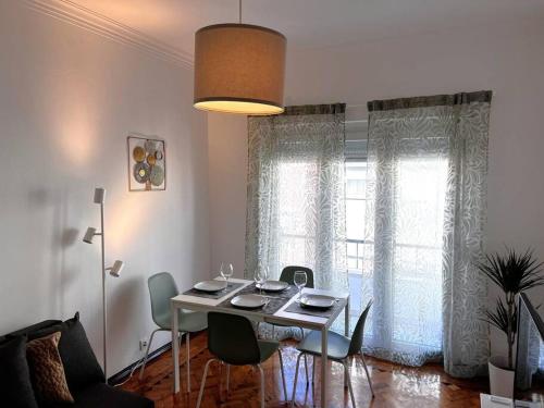 y sala de estar con mesa de comedor y sillas. en Guiki House en Lisboa
