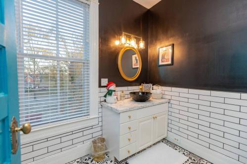 a bathroom with a sink and a mirror and a window at The Bagley House: built in 1911 in Blackstone