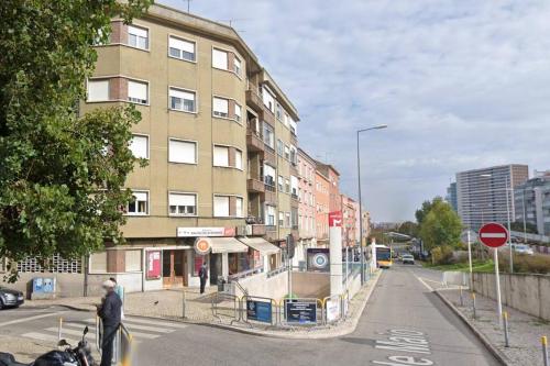 a man crossing a street in front of a building at Guiki House in Lisbon