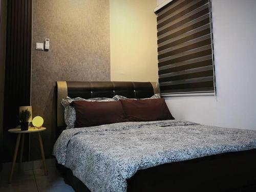 a bedroom with a bed with a black headboard at Youth City Cozy Pool View Homestay Nilai by TR in Nilai