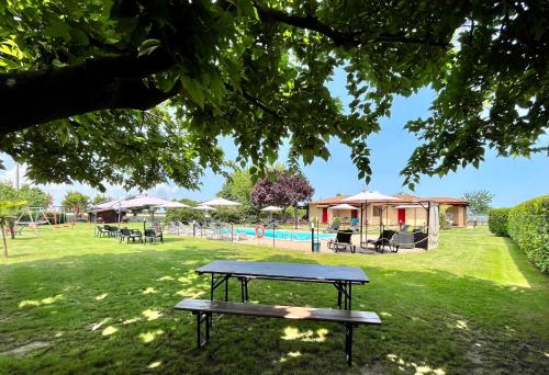 a picnic table in a park with a pool at Oasi di Agilla in Panicarola