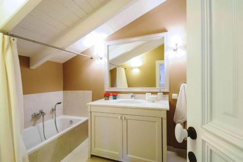 a bathroom with a sink and a mirror at Anelina Paxos Residences ( Nafsika Apartment) in Gaios