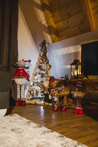 a christmas tree with teddy bears in front of it at Natures Escape Kozarica in Šavnik
