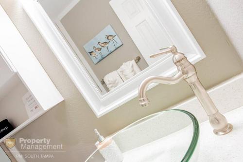 a bathroom sink with a faucet and a mirror at Rays by the Bay in Tampa