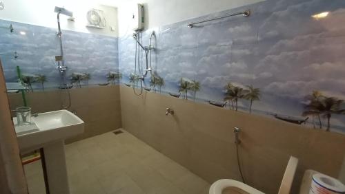 a bathroom with a shower and a toilet and a sink at Nimal's House in Dickwella