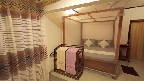 a bedroom with a bunk bed with a mirror at Nimal's House in Dickwella