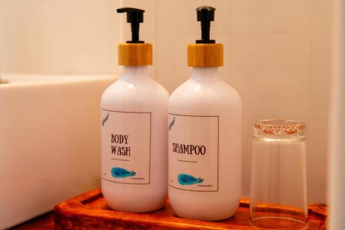 a couple of bottles of soap on a wooden tray at Biosphere Inn in Dharavandhoo