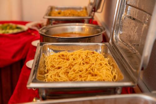 a tray of spaghetti in a microwave at Biosphere Inn in Dharavandhoo