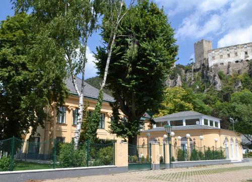 a house with a castle in the background at Wienerwald Residenz in Baden