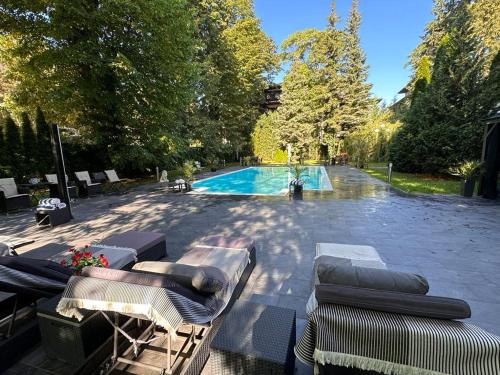 a swimming pool with chaise lounge chairs and a swimming pool at Wienerwald Residenz in Baden
