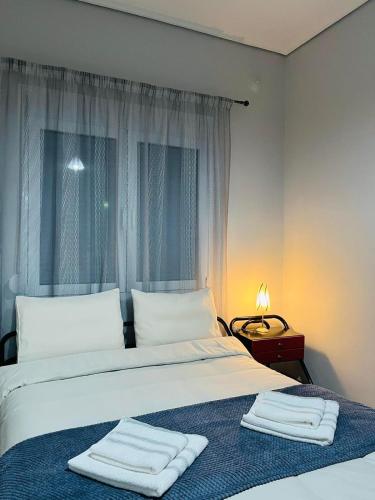 a bedroom with a bed with two towels on it at Billy's cozy place Trikala in Tríkala
