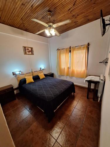 a bedroom with a bed and a ceiling fan at Hotel Vireo in Villa Gesell