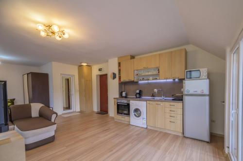 a kitchen with a white refrigerator and a stove at Cozy & Delightful Apart & AUBG & Free Garage Parking in Blagoevgrad